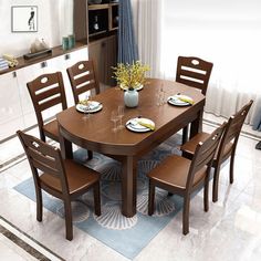 a dining room table with four chairs and a potted plant on top of it