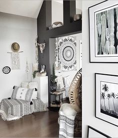 a living room filled with furniture and pictures hanging on the wall above it's doorway