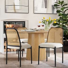 a dining room table with two chairs and a fire place in the fireplace behind it