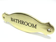 a bathroom door handle with the word bathroom on it's side and an arrow in the middle