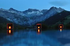 the mountains are reflected in the water at night