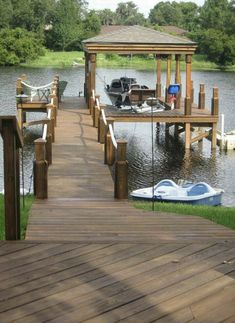 a wooden dock with boats tied to it