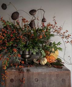 a vase filled with flowers sitting on top of a wooden box