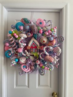 a door with a wreath made out of toys on it's front door handle