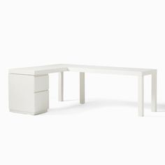 a white desk sitting on top of a white floor