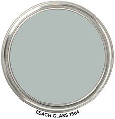 a round mirror with the words beach glass 156a on it and an oval silver frame