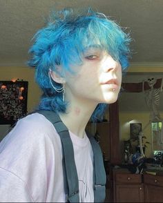 a person with blue hair and suspenders in a room