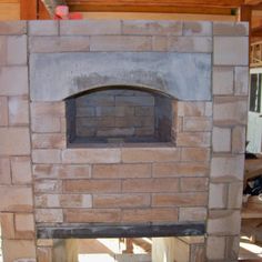 a brick oven in the middle of a room