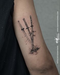 a man's arm with two swords on it