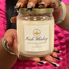 a woman holding a jar with nail polish on her hands and nails in the other hand