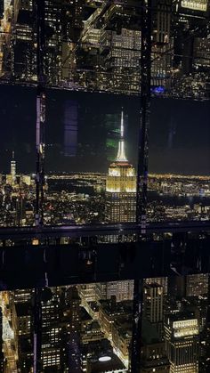 an aerial view of the city lights at night from top of the empire building in new york city