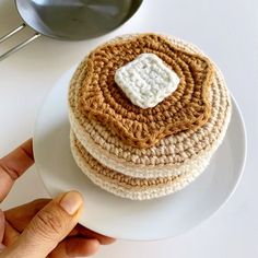 a crocheted cake sitting on top of a white plate