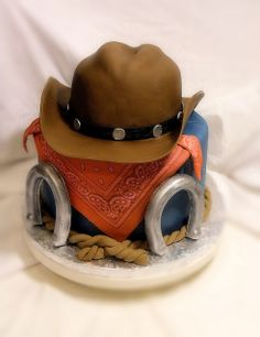 a toy cowboy hat and saddle on a white background