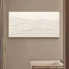 an abstract painting hangs on the wall above a crib in a neutral colored room