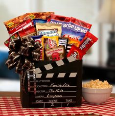 a movie themed gift basket with popcorn and snacks