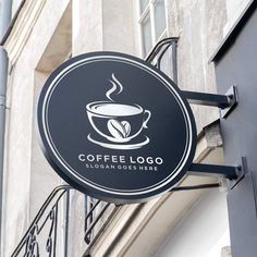 a coffee shop sign hanging from the side of a building