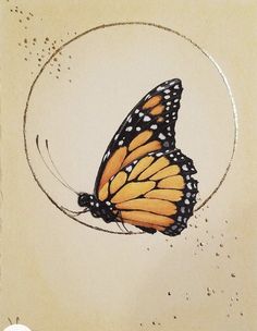 an orange and black butterfly sitting on top of a white circle