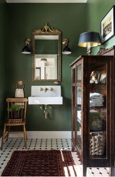 a bathroom with green walls and white flooring