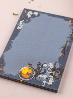 a notepad with cartoon characters on it sitting on a table next to confetti