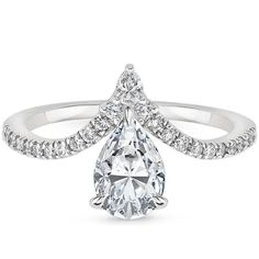 a pear shaped diamond engagement ring on a white background