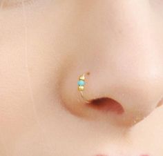 a close up view of a nose piercing