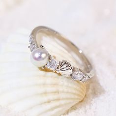 Dive into the mysteries of the deep sea with the Abyssal Pearl Ring. This exquisite piece features a lustrous round pearl, nestled among sparkling round white gems that capture the light like sunbeams breaking through the waves. Adding a touch of whimsy, a seashell sits gracefully among the gems, evoking the serene beauty of the seashore. Let your mermaid soul swim in the ocean's endless magic and adventure. ✦ Available in both 14K white gold vermeil (14K white gold plated over a sterling silver Mermaid Soul, Gold Vermeil Jewelry, August Birthstone Jewelry, July Birthstone Jewelry, Ring White Gold, Vermeil Jewelry, Jewelry Ring Box, Pearl Jewellery Earrings, Men's Jewelry Rings