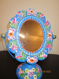 a blue mirror sitting on top of a table