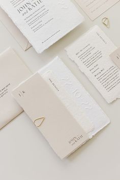 the wedding stationery is laid out on top of each other