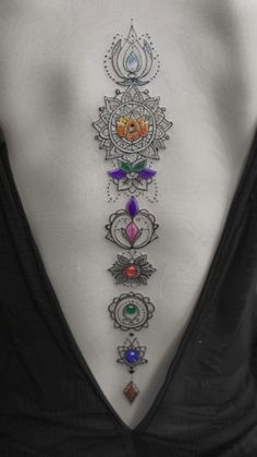 the back of a woman's neck with colorful jewels on it