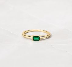 This stunning antique-inspired ring is the perfect choice for any special occasion. The round, eye-clean emerald baguette is set in a prong style, with no additional stones to enhance its natural beauty. The sterling silver band is stackable and can be personalized to fit your needs. The charm style ring is handmade and features a unique design that will make it a cherished addition to your jewelry collection. Whether you're celebrating an engagement, wedding, anniversary, birthday, or Valentine's Day, this ring is sure to impress. The vintage-inspired design is timeless and will never go out of style. Baguette Ring, Antique Inspiration, Birthday Jewelry Gift, Vintage Inspired Design, Sterling Silver Bands, Gold Engagement Rings, Engagement Wedding