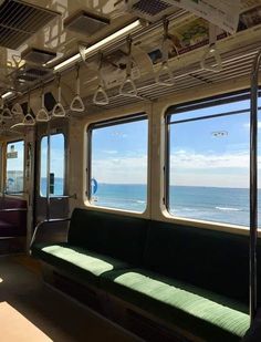 the inside of a train car looking out at the ocean