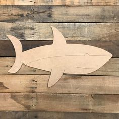 a cutout of a shark on wood planks