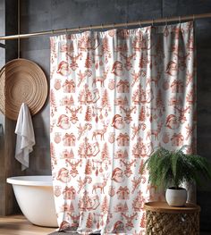 a bathroom with an orange shower curtain next to a bathtub and plant in the corner