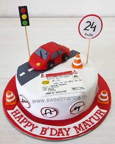 a birthday cake with a red car on top