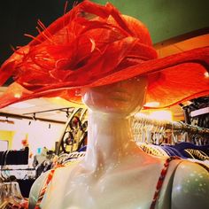 a mannequin wearing a red hat in a store