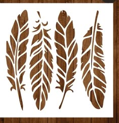 three brown feathers on a white paper next to a wooden background with the words,'feather