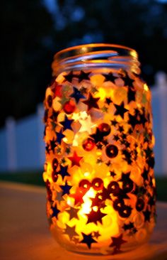 a lit up jar with stars on it