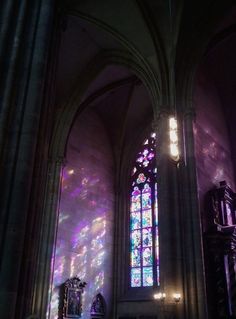 the interior of a cathedral with stained glass windows