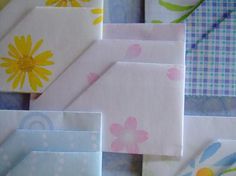 many different colored papers with flowers on them