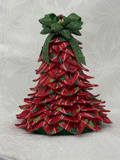 a red and green christmas tree made out of ribbon