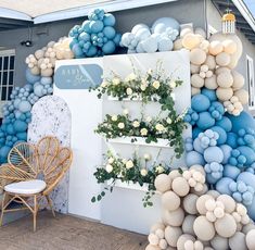 a wall with balloons and flowers on it