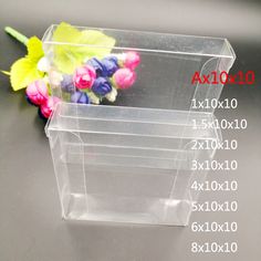 three clear plastic boxes with flowers in them