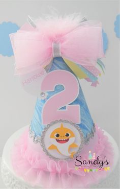 a pink and blue birthday cake with a number two on it's top tier