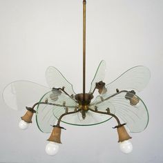 a glass chandelier with five lights hanging from it's center and four arms