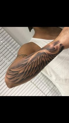 a man's arm with an eagle tattoo on it