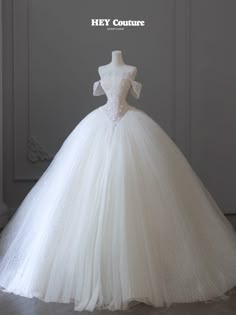 a white wedding dress on display with the words hey couture written above it