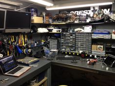 a workbench filled with lots of tools and computer equipment on top of a desk