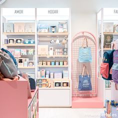 the inside of a store with many items on shelves and bags hanging from it's walls