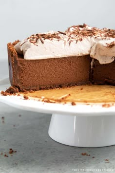 a chocolate cake with frosting and sprinkles on a white platter