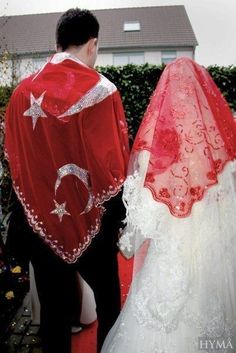 a man and woman dressed up in wedding attire